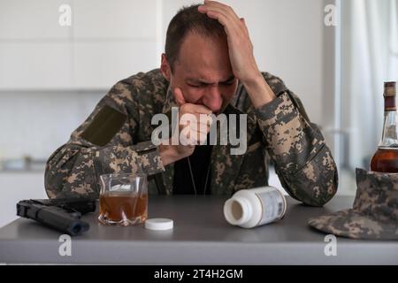 young attractive wasted and depressed addict and alcoholic man with whiskey glass thoughtful and sad failing resisting temptation to drink falling Stock Photo