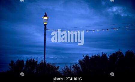 Solitary lamp post set againt a stormy sky in Blackpool during the illuminations Stock Photo