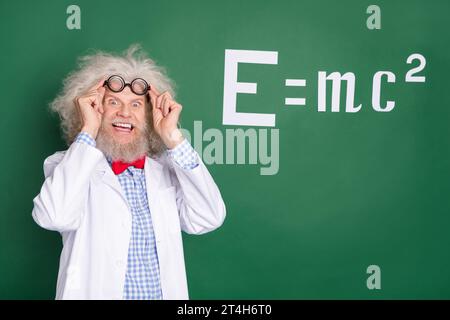 Photo of crazy old professor wear glasses formula board idea mathematics isolated on green color background Stock Photo