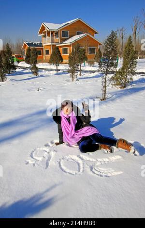 LUANNAN COUNTY - JANUARY 1: woman visitor in a park after snow, on January 1, 2015, Luannan County, Hebei Province, China Stock Photo