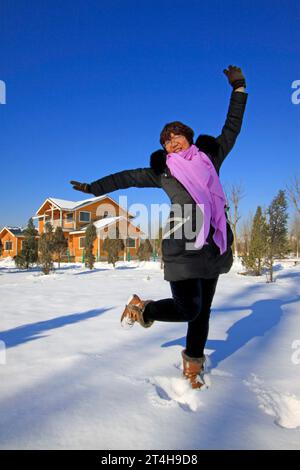 LUANNAN COUNTY - JANUARY 1: woman visitor in a park after snow, on January 1, 2015, Luannan County, Hebei Province, China Stock Photo