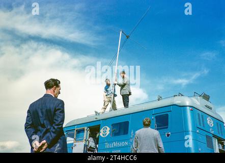 ATV television ITV company outside broadcast vehicle, erecting television antenna aerial on top of van, UK 1960s Stock Photo