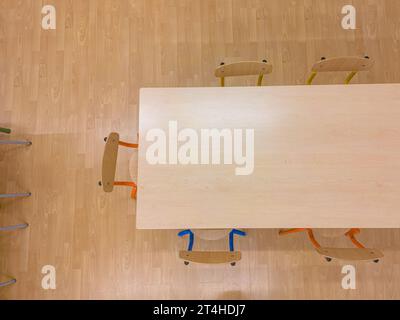 Aerial view of a school classroom, with brown chairs and tables Stock Photo