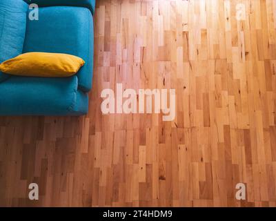 Aerial view of a dining room, brown parquet and green sofa Stock Photo