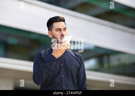 Arabic Business Man Using Voice Search Application On Smartphone Outdoors Stock Photo