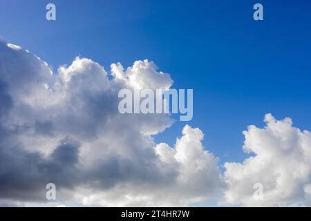 Blue sky background with fluffy grey and white clouds Stock Photo