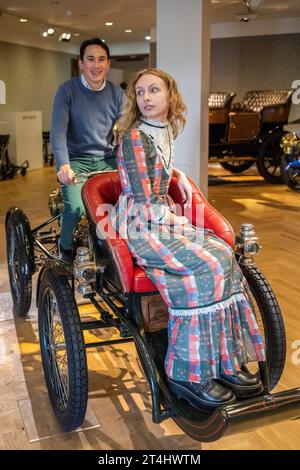 London, UK.  31 October 2023. Staff members on a 1900 De Dion Bouton 275cc Single-Cylinder Quadricycle, estimate: £50,000-£60,000, at a preview for the Bonhams Cars Golden Age of Motoring Sale.  Of the 31 vehicles offered in the sale, 21 are pre-1905 and eligible to participate in the London to Brighton Vintage Car Run.  The sale takes place on 3 November at Bonhams New Bond Street galleries.  Credit: Stephen Chung / Alamy Live News Stock Photo