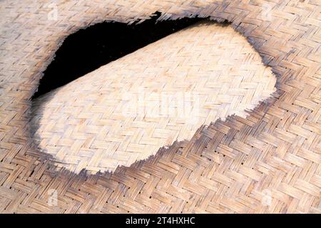 Burn a hole in the reed mat, closeup of photo Stock Photo