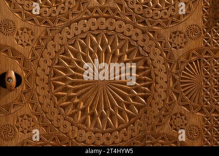 Handmade carving decoration, circular pattern is on an old wooden furniture Stock Photo