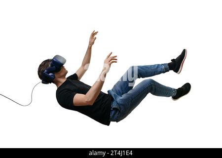 Isolated young men falling in zero gravity space while using virtual reality glasses on white background. 3d simulation headset Stock Photo