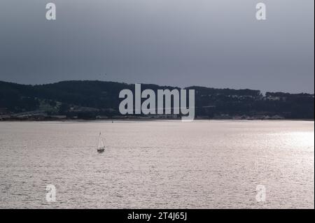 A sailboat in the San Francisco Bay at sunset Stock Photo