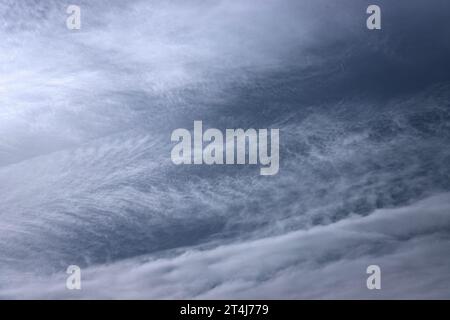 A high altitude milky veil of Cirrostratus has structure created by high altitude winds. These formations produce no rain but are extensive, Stock Photo