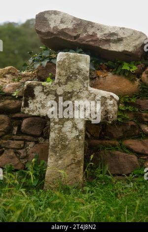 Stone cross in an Irish cemetery, in daylight, space for text copy.Suitable for any project related to spirituality, religion, funerals, solitude, dis Stock Photo