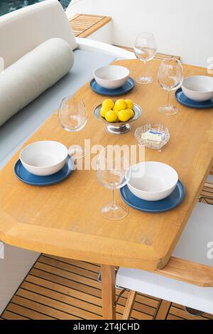 Dining table set for lunch on a luxury yacht deck Stock Photo
