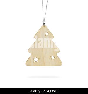 Merry Christmas and happy new year concept. Hanging wooden Christmas tree ornament on white background. Festive Christmas object. Stock Photo