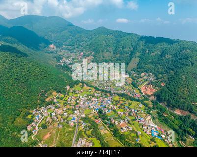 Aerial view of Kathmandu valley, temple on the hills. The monastery is surrounded by lush green hills. Rinpoche Statue, Asura Cave, Old Dashinkali Stock Photo