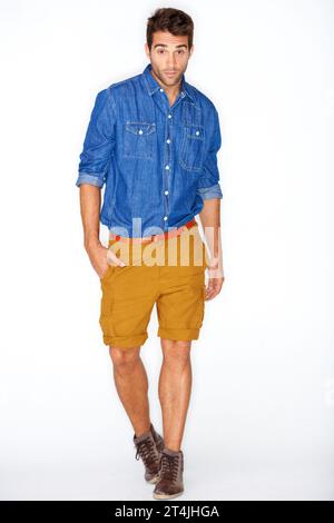 Stylish, portrait and a man or model with fashion, unique style or clothes on a white background. Cool, walking and handsome guy or person in hipster Stock Photo