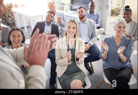 Put your hands together for that. a group of businesspeople clapping hands in a meeting at work. Stock Photo