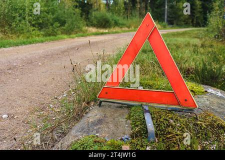 Warning triangle next to a small gravel road in Finland. Stock Photo