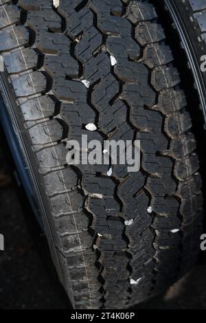 Small stones caught in the tread of truck tyre which can cause a danger ...