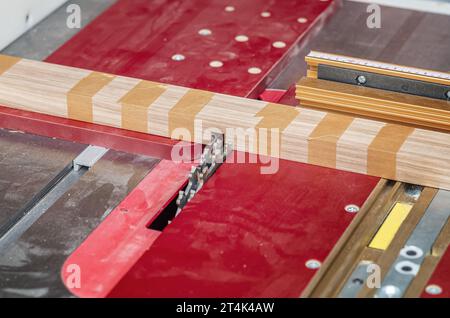 A circular saw cuts a groove in the board. Carpentry Stock Photo
