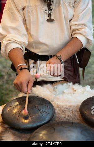 Italy, Lombardy, Historical Reenactment, Man Playing Steel Tongue Drum Stock Photo