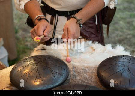 Italy, Lombardy, Historical Reenactment, Man Playing Steel Tongue Drum Stock Photo