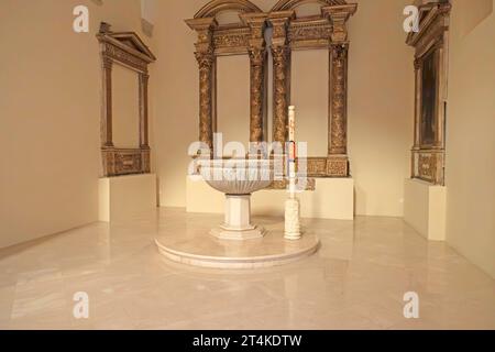 The baptismal font in the parish church of Saint Anthony (Parrocchia Sant’Antonio) in Monopoli, Italy. Stock Photo