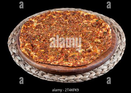Turkish pizza Lahmacun with minced lamb and beef on a thin crust with vegetables and herbs, horizontal layout. Wooden table, top view, flat lay, copy Stock Photo