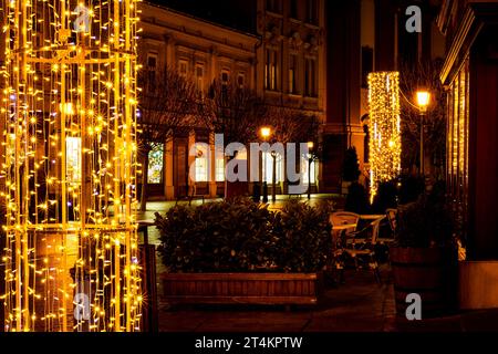 Colorful christmas lights with blurred street lights in the background at night Stock Photo