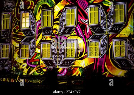 House walls illuminated with colorful advent calendars on a night street before Christmas Stock Photo
