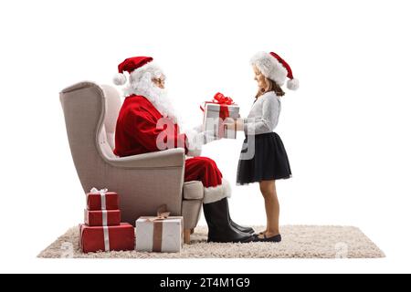 Santa Claus Giving Gift To Girl Stock Photo - Alamy