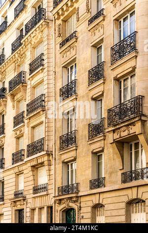 Façade of a typical and elegant residential building in Passy quarter, Paris, France, with wrought iron railings and balconies Stock Photo