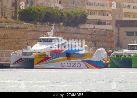 “Gozo Express” (foreground) and “Your Wisdom” provide a 45 minute fast catamaran ferry service between Valletta, Malta and Mgarr, Gozo, April 2023. Stock Photo