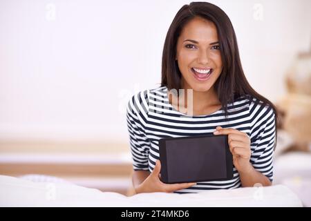 Im so excited about my new app. Portrait of an attractive young woman holding up her digital tablet. Stock Photo