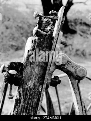 A 1980 black and white, medium format photograph of parts of a timber wagon or dray with rotting weathered timber and iron bolts in a paddock near Sofala in Central Western New South Wales, Australia Stock Photo