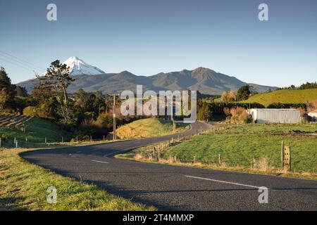 Rural backroad running through farm pasture land, Taranaki, New Zealand Stock Photo