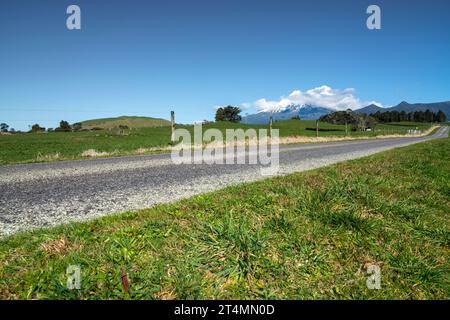 Rural backroad running through farm pasture land, Taranaki, New Zealand Stock Photo