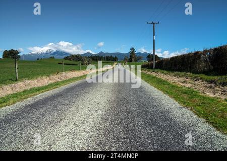 Rural backroad running through farm pasture land, Taranaki, New Zealand Stock Photo