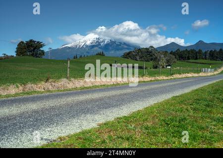 Rural backroad running through farm pasture land, Taranaki, New Zealand Stock Photo