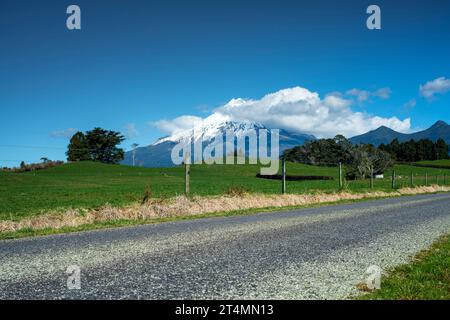 Rural backroad running through farm pasture land, Taranaki, New Zealand Stock Photo
