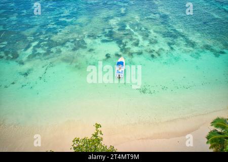 Drone of baie lazare beach,  docking fisherman boat on low tide near  the shore, turquoise water, sunny day, Mahe Seychelles Stock Photo