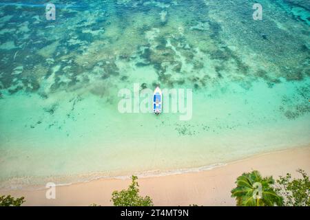 Drone of baie lazare beach,  docking fisherman boat on low tide near  the shore, turquoise water, sunny day, Mahe Seychelles Stock Photo