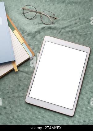 Tablet empty white screen and notebooks  on the office desk Stock Photo
