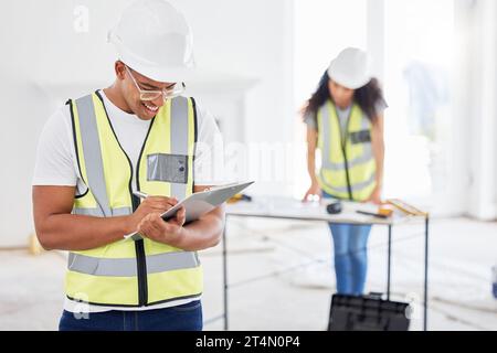 Were ready to build your dream home. a handsome young contractor standing inside and using a clipboard. Stock Photo