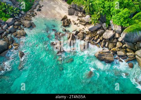 Bird eye drone shot of north east point beach, granite rocks, turquoise water, white sandy beach, waves crashing, greenery, Mahe Seychelles Stock Photo