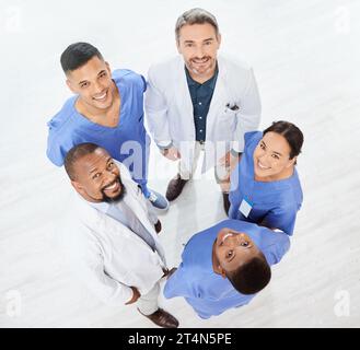 Checking the stats as a team. a group of medical practitioners standing together in a hospital. Stock Photo