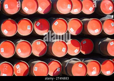 a stack of red barrels in an industrial setting Stock Photo