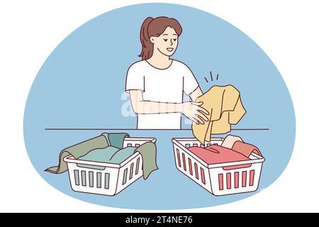 Woman sorting dirty clothes for washing. Girl gathering laundry in ...