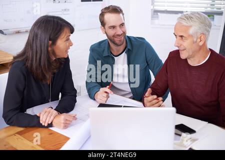 The architectural dream team. three architects working on a new building design. Stock Photo